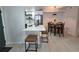 Modern kitchen with breakfast bar, stainless steel appliances, stylish lighting, and adjacent dining area for easy entertaining at 14433 E Jewell Ave # 101, Aurora, CO 80012