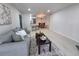 Open concept living area featuring a gray sofa, modern furnishings, and an adjacent kitchen and dining space at 14433 E Jewell Ave # 101, Aurora, CO 80012