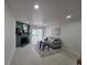 Bright living room with decorative fireplace, gray sofa, and sliding glass doors leading to the private outdoor patio at 14433 E Jewell Ave # 101, Aurora, CO 80012
