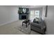 Bright living room with decorative fireplace, gray sofa, and sliding glass doors leading to the private outdoor patio at 14433 E Jewell Ave # 101, Aurora, CO 80012