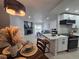 Open living space featuring a modern kitchen, cozy living room with fireplace, and stylish dining area at 14433 E Jewell Ave # 101, Aurora, CO 80012