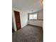 Neutral bedroom with trim, large window, and wood door at 3097 W 134Th Way, Broomfield, CO 80020