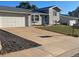 Inviting home featuring a spacious driveway leading to an attached garage and a neatly landscaped lawn at 3097 W 134Th Way, Broomfield, CO 80020