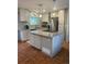 Well-lit kitchen featuring a granite countertop island, stainless steel appliances, and hardwood floors at 3097 W 134Th Way, Broomfield, CO 80020