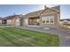 Well-maintained backyard with manicured lawn, patio, and a charming exterior at 8778 S Quatar St, Aurora, CO 80016