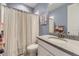 Cozy bathroom with a shower-tub combo and decorative striped shower curtain at 8778 S Quatar St, Aurora, CO 80016