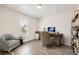 Well-appointed bedroom with a sleek desk, a cozy chair, and natural light from the window at 8778 S Quatar St, Aurora, CO 80016