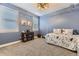 Serene bedroom with blue walls, natural light, and a comfortable bed with playful bedding at 8778 S Quatar St, Aurora, CO 80016