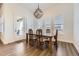 Cozy dining room with modern light fixture and door that leads to the patio at 8778 S Quatar St, Aurora, CO 80016