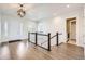 Welcoming entryway with hardwood floors, stylish lighting, and staircase leading to the upper level at 8778 S Quatar St, Aurora, CO 80016