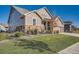 Attractive home exterior with lush green lawn, stone veneer, and a welcoming front entrance at 8778 S Quatar St, Aurora, CO 80016