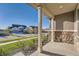 View from front porch showing the street, neighboring homes, and manicured lawns at 8778 S Quatar St, Aurora, CO 80016