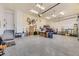 Spacious garage with epoxy flooring, ample storage space, and overhead lighting at 8778 S Quatar St, Aurora, CO 80016