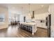 Bright kitchen with white cabinets, a large island, and modern appliances for cooking convenience at 8778 S Quatar St, Aurora, CO 80016