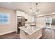 Modern kitchen island with granite countertops, stainless steel appliances, and pendant lighting at 8778 S Quatar St, Aurora, CO 80016