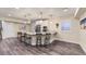 Charming kitchen island with granite countertops, seating, and modern pendant lighting fixtures at 8778 S Quatar St, Aurora, CO 80016