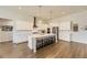 Modern kitchen featuring white cabinets, an island with seating, and stainless steel appliances at 8778 S Quatar St, Aurora, CO 80016