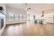 Bright open-concept living room with fireplace, ample windows, flowing into the modern kitchen at 8778 S Quatar St, Aurora, CO 80016
