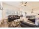 Bright living room featuring a ceiling fan and an open floor plan leading to the kitchen at 8778 S Quatar St, Aurora, CO 80016