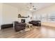 Cozy living room featuring a fireplace, hardwood floors, and natural light from large windows at 8778 S Quatar St, Aurora, CO 80016