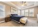 Serene main bedroom with tray ceiling, ceiling fan, plantation shutters, and a king bed at 8778 S Quatar St, Aurora, CO 80016