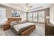 Spacious main bedroom with tray ceilings, fan, and sunny windows at 8778 S Quatar St, Aurora, CO 80016