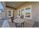 Charming covered patio with outdoor seating, perfect for enjoying the beautiful backyard view at 8778 S Quatar St, Aurora, CO 80016