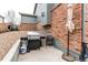 Backyard with grill, small patio, chair, and umbrella at 6488 S Kewaunee Way, Aurora, CO 80016
