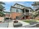 Exterior view of home showcasing a large backyard with seating, grill, and stairs to the patio at 6488 S Kewaunee Way, Aurora, CO 80016
