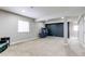 Spacious basement featuring neutral carpet, recessed lighting, and a folding ping pong table for entertainment at 6488 S Kewaunee Way, Aurora, CO 80016