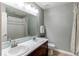 Bathroom with double sinks, a large mirror, and a separate shower and toilet area at 6488 S Kewaunee Way, Aurora, CO 80016