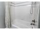 Bathroom with a bathtub, shower, and tiled wall at 6488 S Kewaunee Way, Aurora, CO 80016