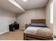 Cozy bedroom with neutral color palette, including a wooden bed frame, desk, and ample natural light at 6488 S Kewaunee Way, Aurora, CO 80016