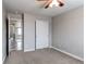 Neutral bedroom features a closet with sliding doors and access to the hallway at 6488 S Kewaunee Way, Aurora, CO 80016