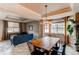 Open concept dining room with a wood table, modern light fixture, and natural light at 6488 S Kewaunee Way, Aurora, CO 80016