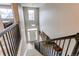 Interior view of a two-story foyer with modern staircase and front door view at 6488 S Kewaunee Way, Aurora, CO 80016