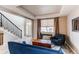 Bright living room with a staircase, comfortable seating, and a coffered ceiling at 6488 S Kewaunee Way, Aurora, CO 80016