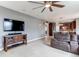 Open-concept living room with a TV, fireplace, and views into the connected kitchen and dining area at 6488 S Kewaunee Way, Aurora, CO 80016