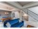 Open-concept living room with a view of dining area and staircase, and comfortable seating at 6488 S Kewaunee Way, Aurora, CO 80016