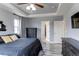 Main bedroom featuring a tray ceiling, two windows, and access to a walking closet at 6488 S Kewaunee Way, Aurora, CO 80016