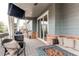 Covered patio featuring a grill, fire pit, seating, and outdoor TV at 6488 S Kewaunee Way, Aurora, CO 80016