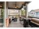 Covered deck with outdoor furniture, a ceiling fan, and mounted television at 6488 S Kewaunee Way, Aurora, CO 80016