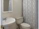 Bathroom features a pedestal sink, toilet, and shower with patterned curtain at 8746 Mariposa St, Thornton, CO 80260