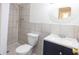 Full bathroom showcasing tiled walls, tiled shower stall and vanity with storage at 8746 Mariposa St, Thornton, CO 80260