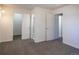 The bedroom has neutral carpeting and multiple doors for accessing the closet and bathroom at 8746 Mariposa St, Thornton, CO 80260