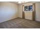 The bedroom features neutral carpet and curtains with a window overlooking mature trees at 8746 Mariposa St, Thornton, CO 80260