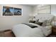 Bright bedroom with modern decor features comfortable bed, soft lighting, and a window with neighborhood views at 8746 Mariposa St, Thornton, CO 80260