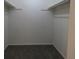 Walk-in closet featuring neutral carpeting and clothing rods for optimal storage at 8746 Mariposa St, Thornton, CO 80260