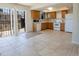 Bright eat-in kitchen with wood cabinetry, modern appliances, and access to the patio at 8746 Mariposa St, Thornton, CO 80260