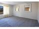 Spacious living room with neutral wall paint, large windows, and plush carpeting at 8746 Mariposa St, Thornton, CO 80260